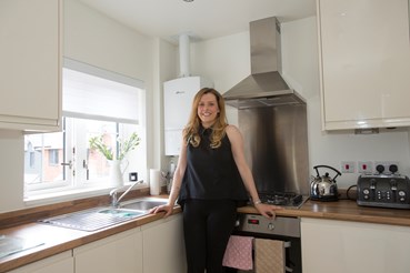 Jessica Kirby standing in her kitchen